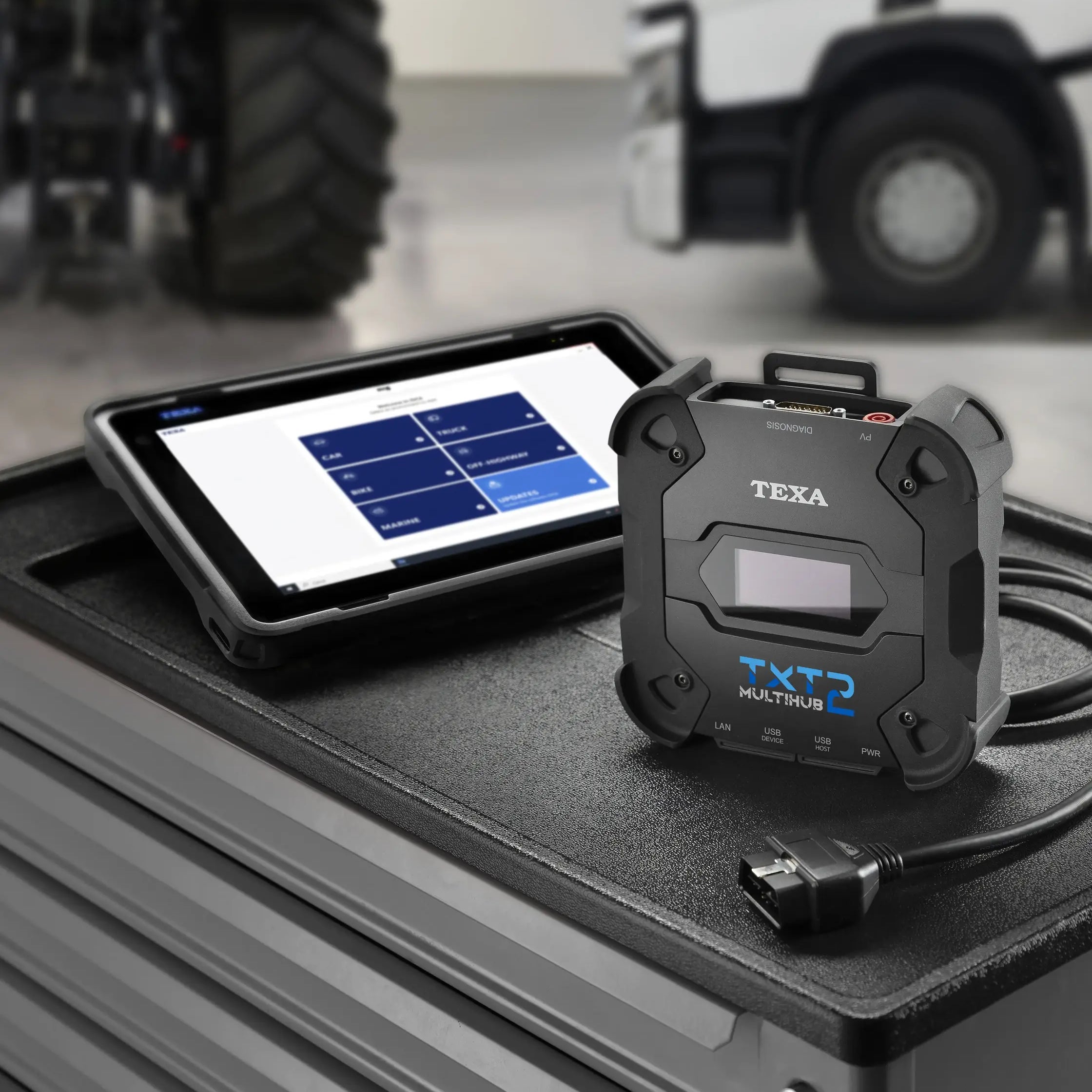 TEXA TXT 2 diagnostic tool on a truck bed with a TEXA Voice tablet displaying software interface.
