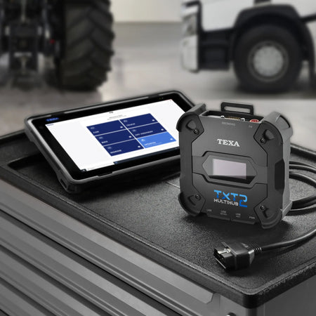 TEXA TXT 2 diagnostic tool on a truck bed with a TEXA Voice tablet displaying software interface.